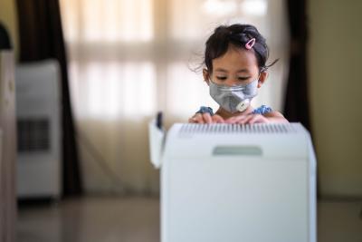 Girl in front of air purifier